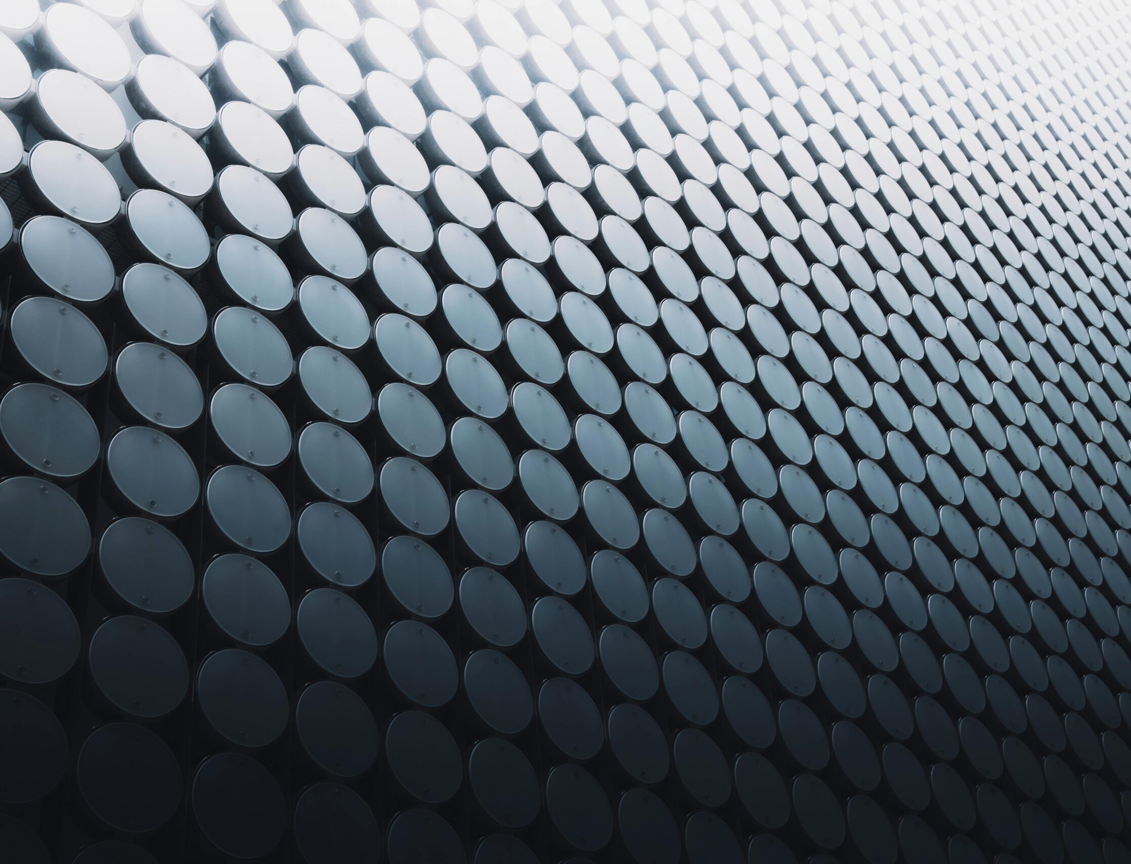 Abstract view of a futuristic building facade in Melbourne, featuring a geometric pattern with reflective surfaces.